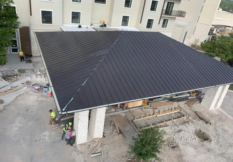 Metal roofing installation team working on a commercial building in Waggaman